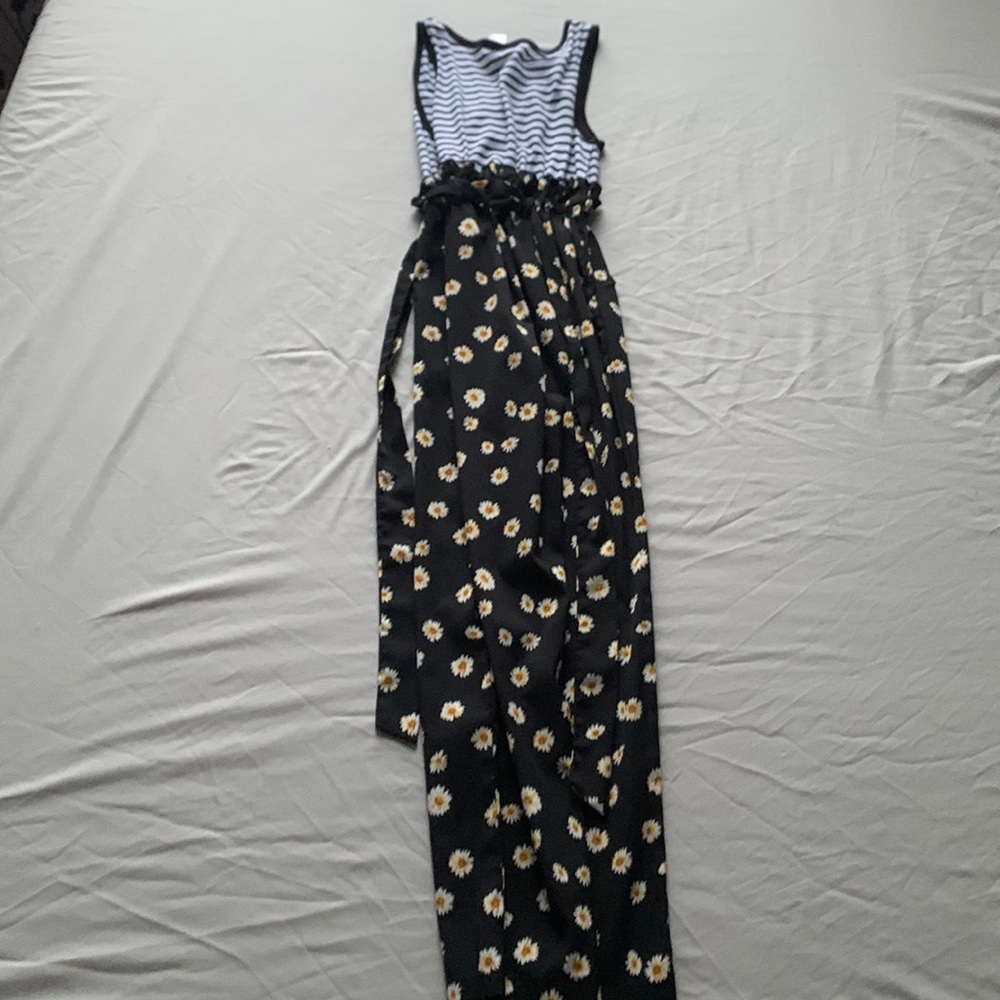 This piece is a jumper with a sunflower printed bottom and a stripped top.